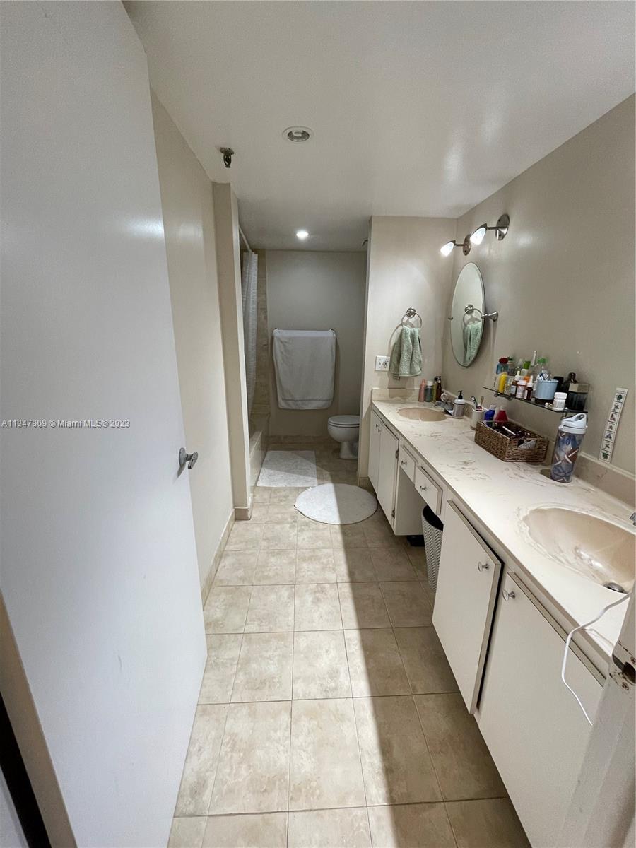 Ives Estates Miami, FL 33179 - Photo 14 of 34 a bathroom with a double vanity sink and a mirror