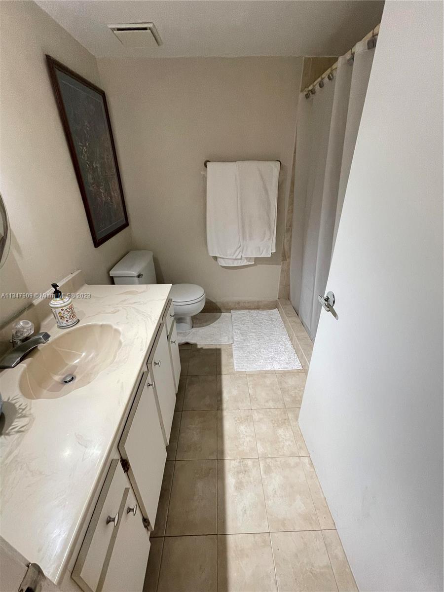 Ives Estates Miami, FL 33179 - Photo 18 of 34 a bathroom with a sink a toilet and mirror