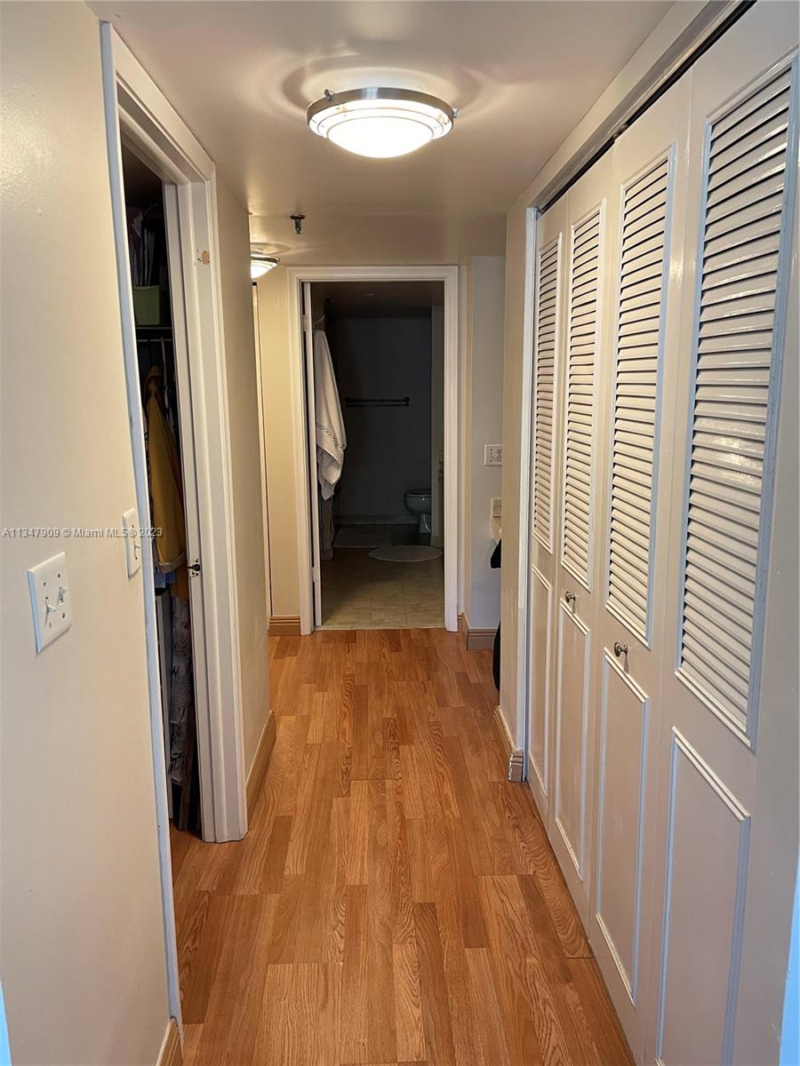 Ives Estates Miami, FL 33179 - Photo 9 of 34 a view of a hallway with wooden floor and staircase