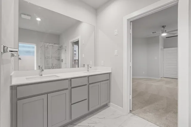 a bathroom with double sink and a mirror