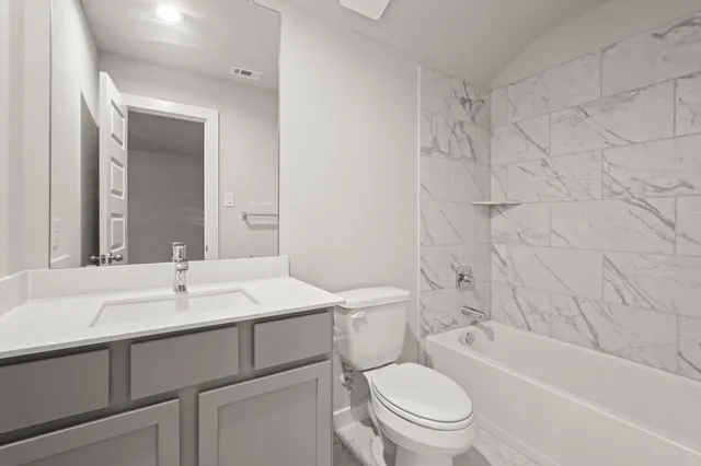 a view of a house with a big yard and large tree