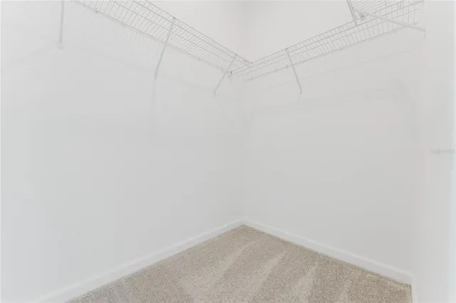 a white toilet sitting next to a white wall