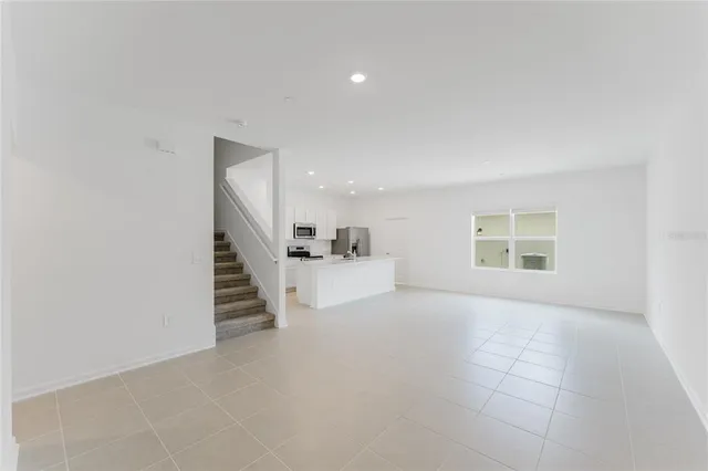 a view of kitchen and hall with wooden floor