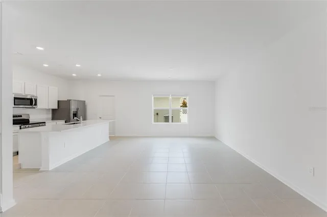 a view of kitchen with stainless steel appliances a refrigerator sink and stove