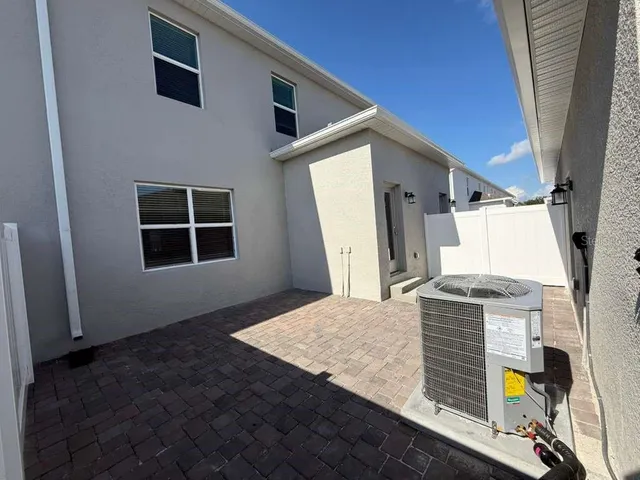 an aerial view of a house with a garden and trees