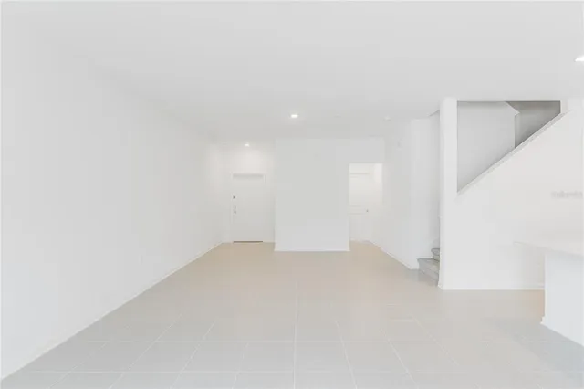 a view of an empty room with stairs