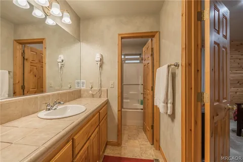 a bathroom with a sink double vanity and a mirror