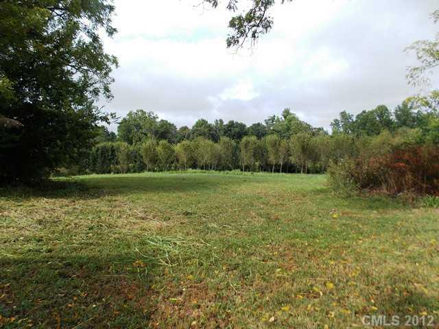 370 Dutchman Road Harmony, NC 28634 - Photo 4 of 11 a view of a green field with wooden fence