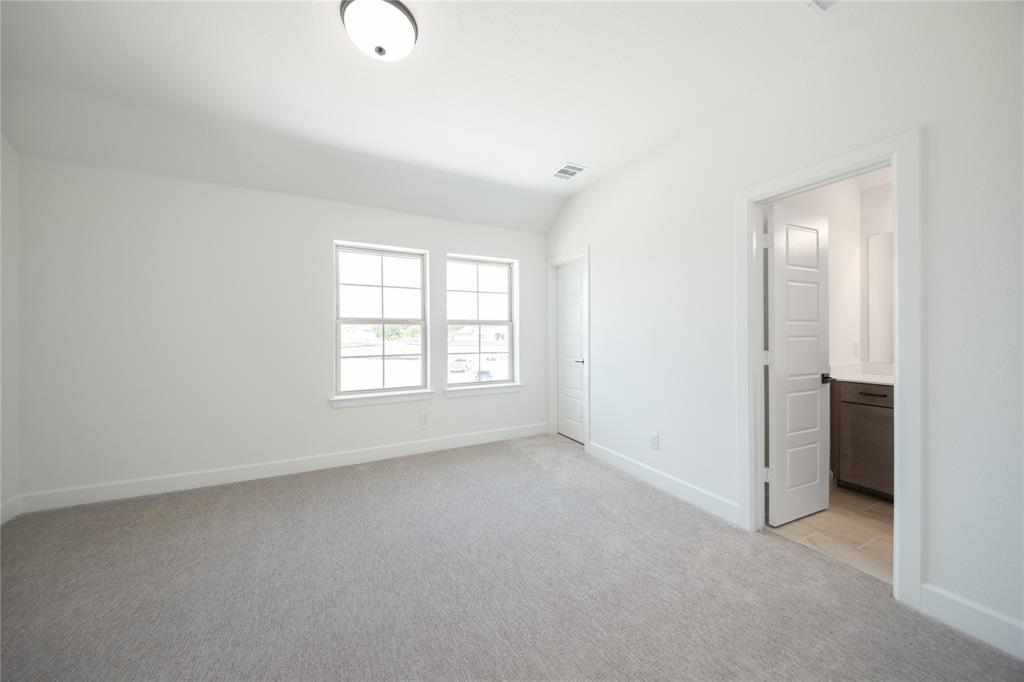 2719 Triumph Court Heath, TX 75126 - Photo 10 of 39 an empty room with windows and closet