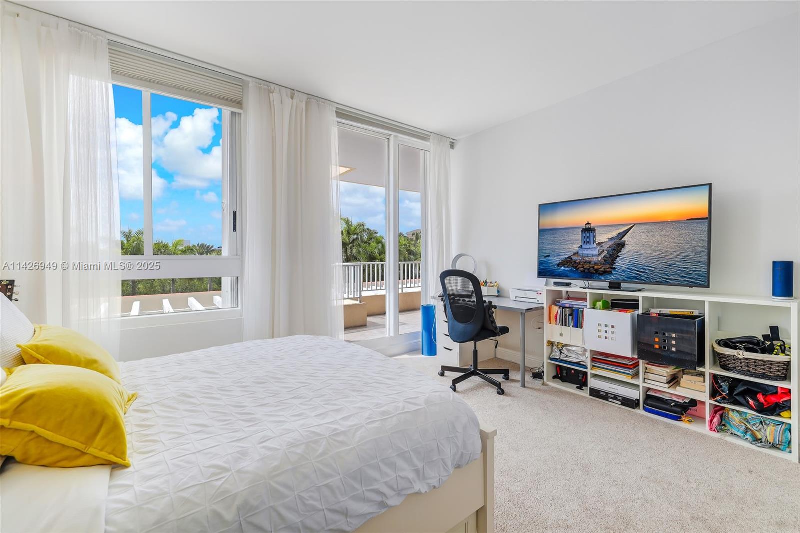 789 Crandon Boulevard, Unit 403 Key Biscayne, FL 33149 - Photo 12 of 27 a bedroom with furniture and a flat screen tv
