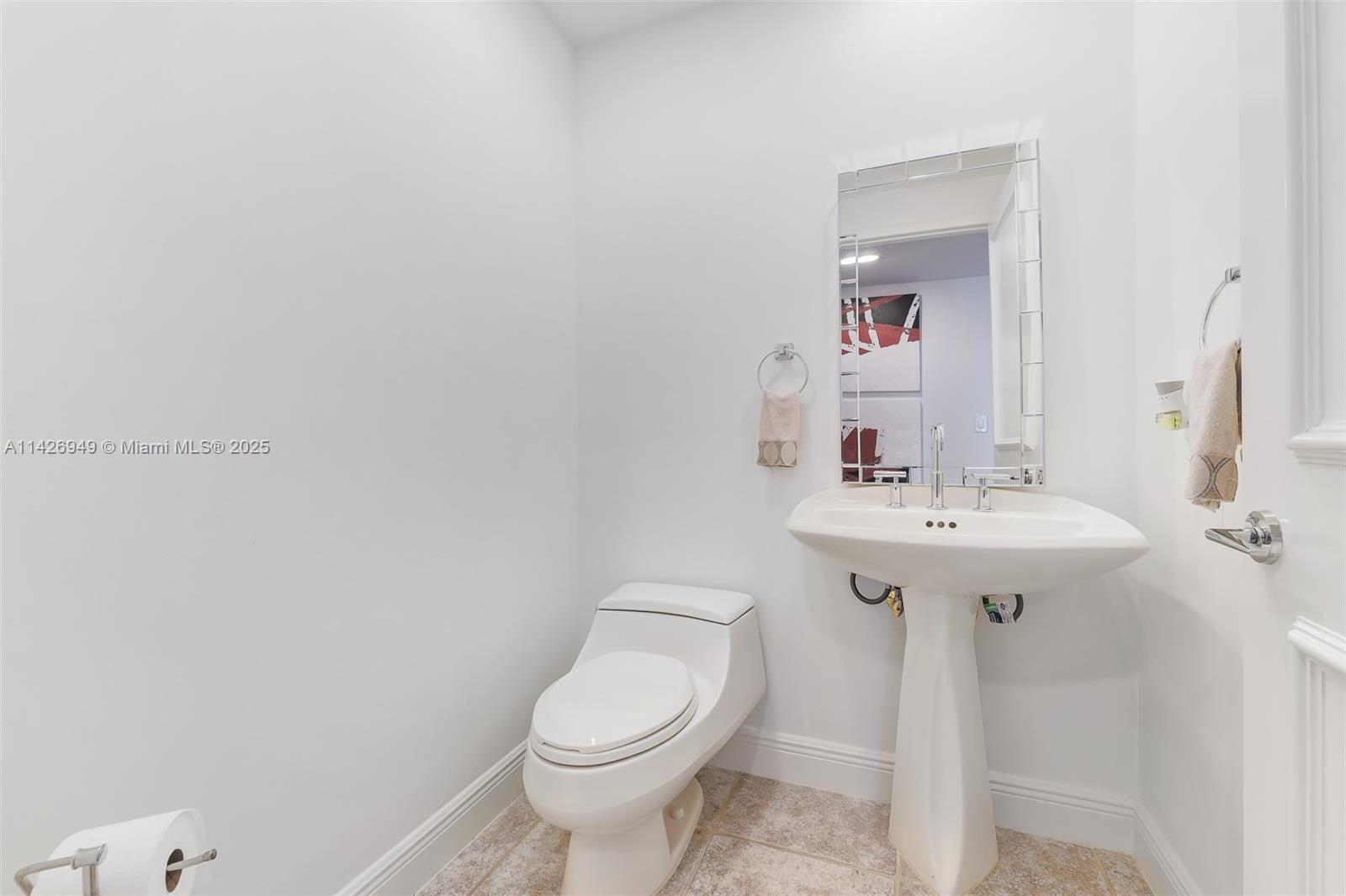 789 Crandon Boulevard, Unit 403 Key Biscayne, FL 33149 - Photo 14 of 27 a bathroom with a sink toilet and a mirror