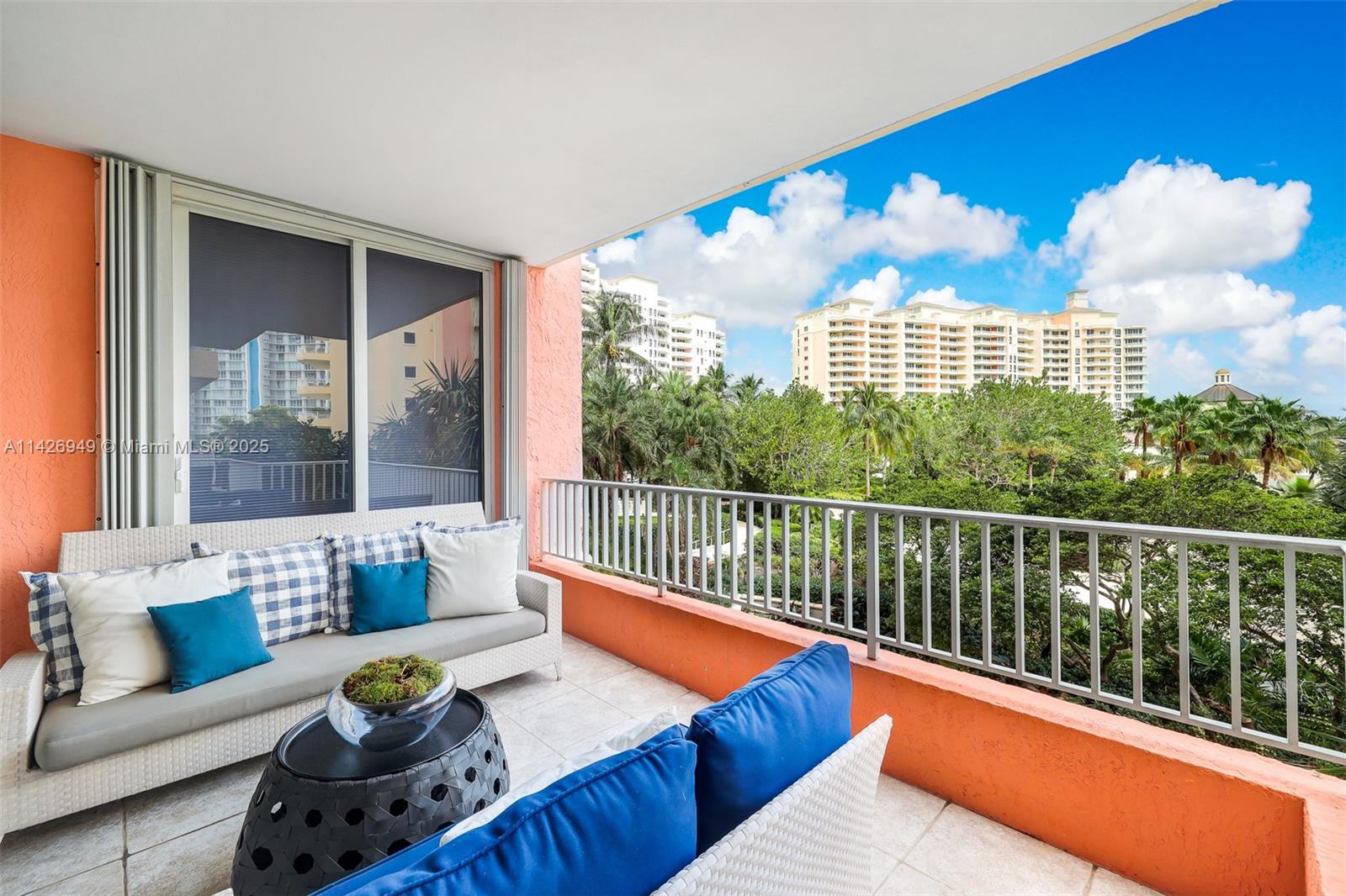 789 Crandon Boulevard, Unit 403 Key Biscayne, FL 33149 - Photo 18 of 27 a view of a balcony with dining table and chairs