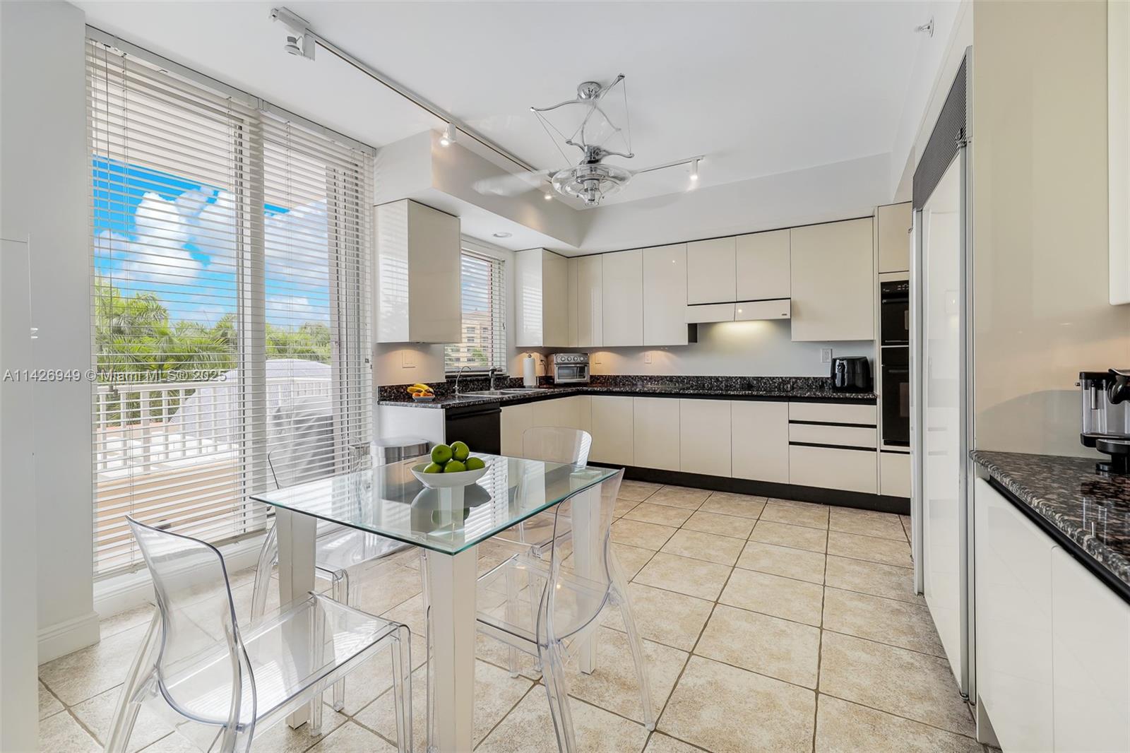 789 Crandon Boulevard, Unit 403 Key Biscayne, FL 33149 - Photo 5 of 27 a kitchen with stainless steel appliances granite countertop a stove a sink and a refrigerator