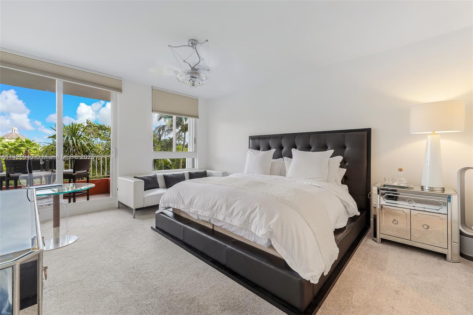 789 Crandon Boulevard, Unit 403 Key Biscayne, FL 33149 - Photo 7 of 27 a bed room with a bed and a large window