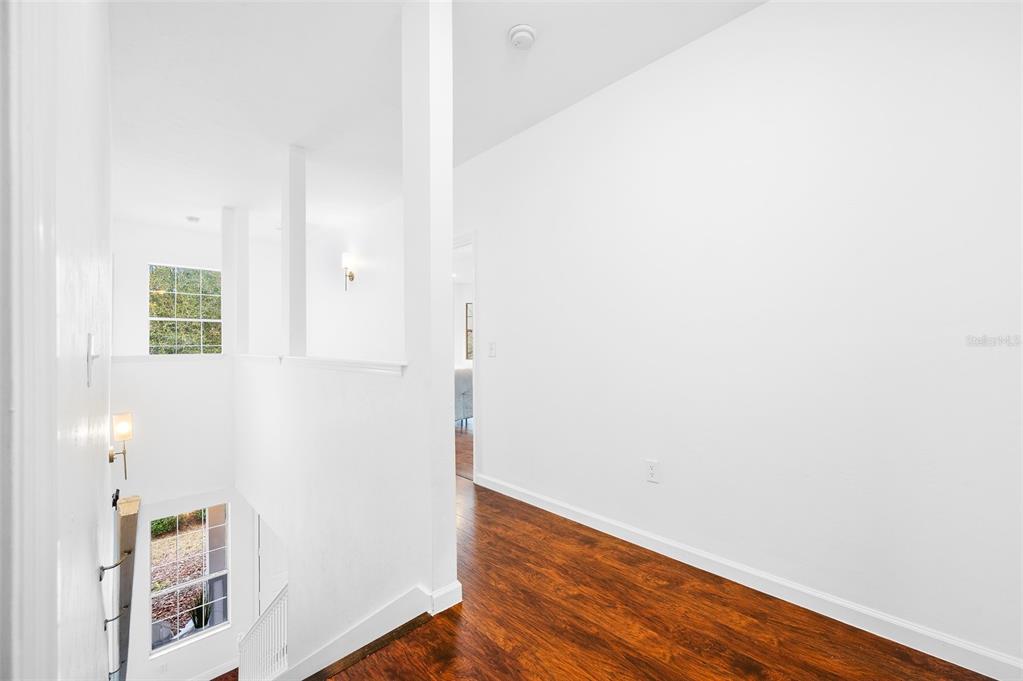 9405 Southwest 31st Lane Gainesville, FL 32608 - Photo 18 of 45 a view of an empty room with wooden floor and closet