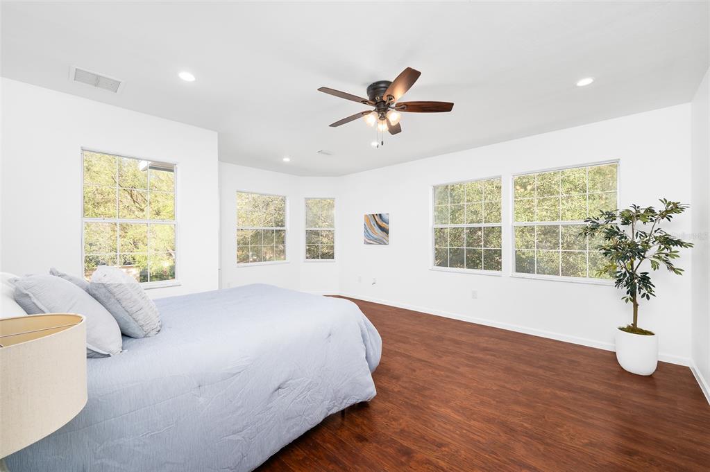 9405 Southwest 31st Lane Gainesville, FL 32608 - Photo 19 of 45 a spacious bedroom with a large bed and a large window