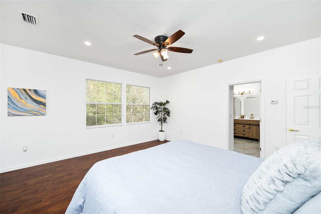 9405 Southwest 31st Lane Gainesville, FL 32608 - Photo 21 of 45 a bedroom with a bed and a large window