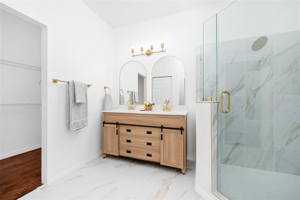 9405 Southwest 31st Lane Gainesville, FL 32608 - Photo 22 of 45 a bathroom with a double vanity sink mirror and shower