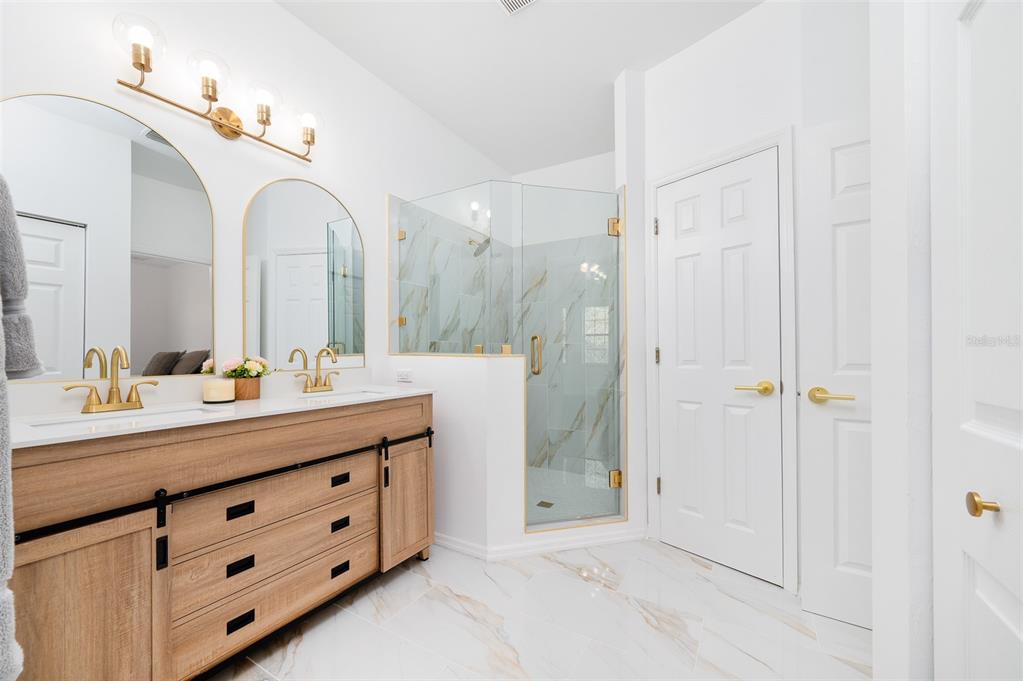 9405 Southwest 31st Lane Gainesville, FL 32608 - Photo 23 of 45 a bathroom with a double vanity sink mirror and double