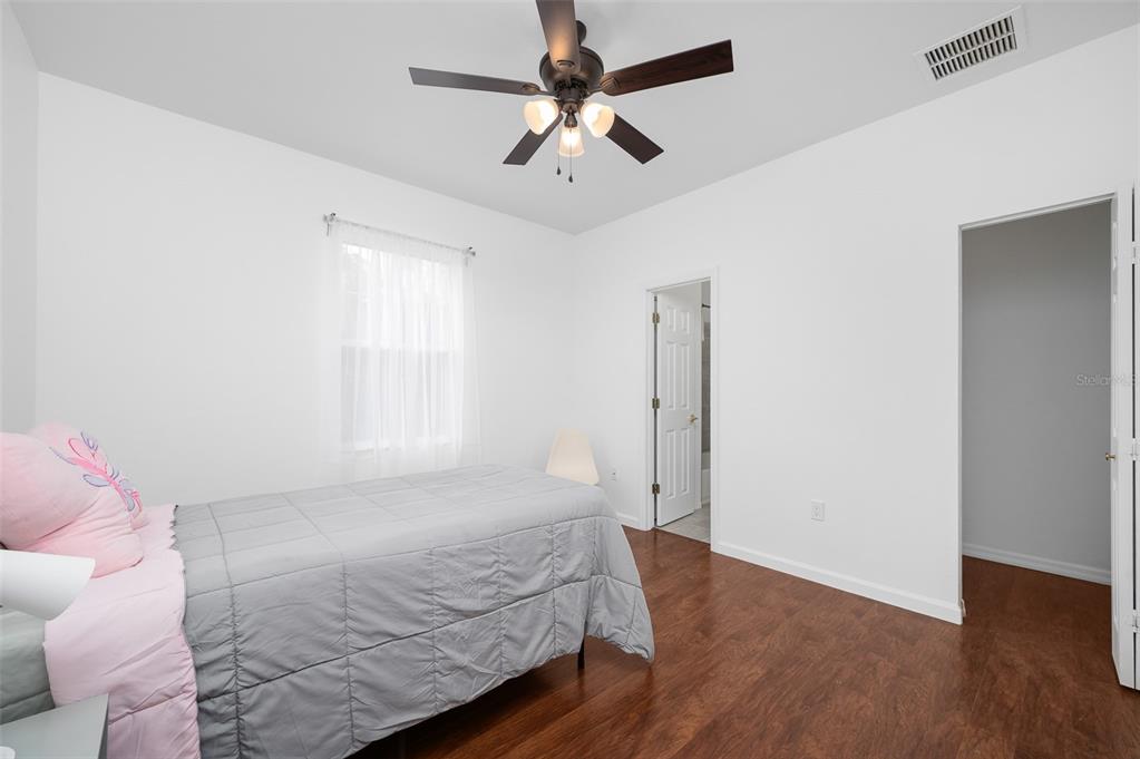 9405 Southwest 31st Lane Gainesville, FL 32608 - Photo 31 of 45 a bedroom with a bed chandelier and a window