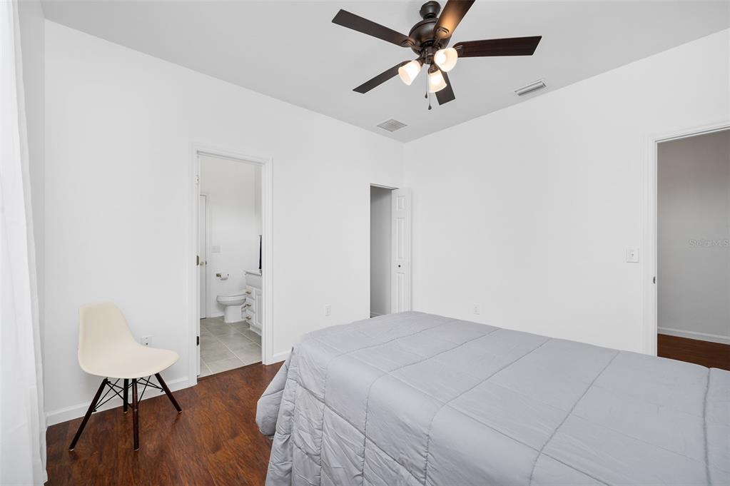 9405 Southwest 31st Lane Gainesville, FL 32608 - Photo 32 of 45 a bedroom with a bed chandelier and a window