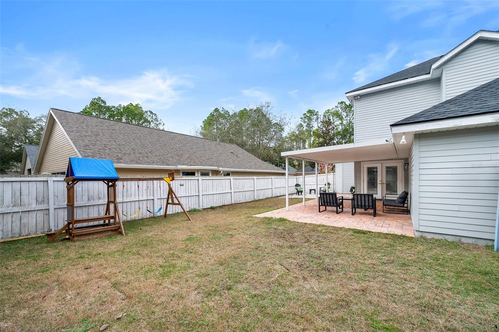 9405 Southwest 31st Lane Gainesville, FL 32608 - Photo 35 of 45 front view of a house with table and chairs in patio