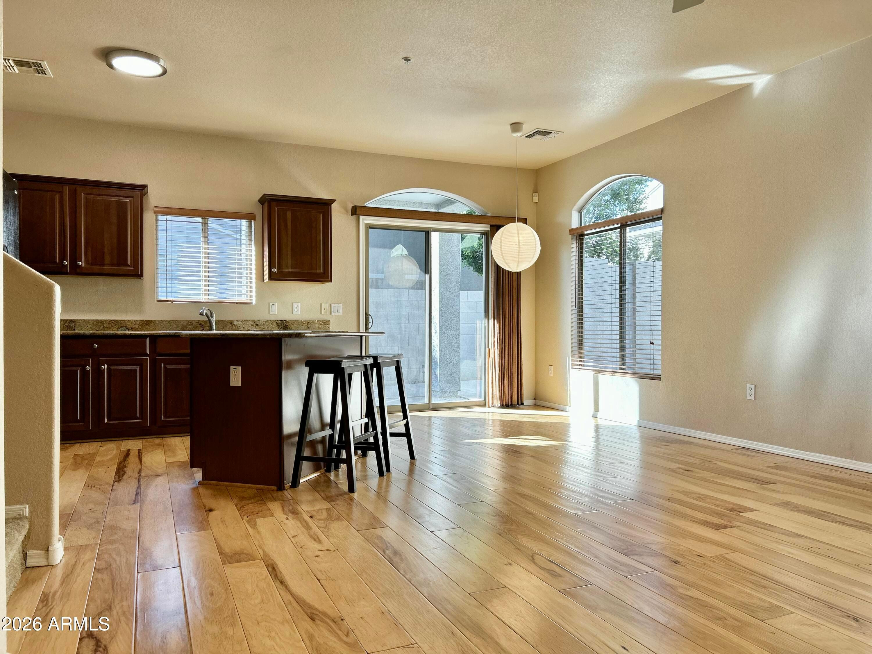 2401 East Rio Salado Parkway, Unit 1018 Tempe, AZ 85288 - Photo 5 of 19 a view of a kitchen with furniture and wooden floor
