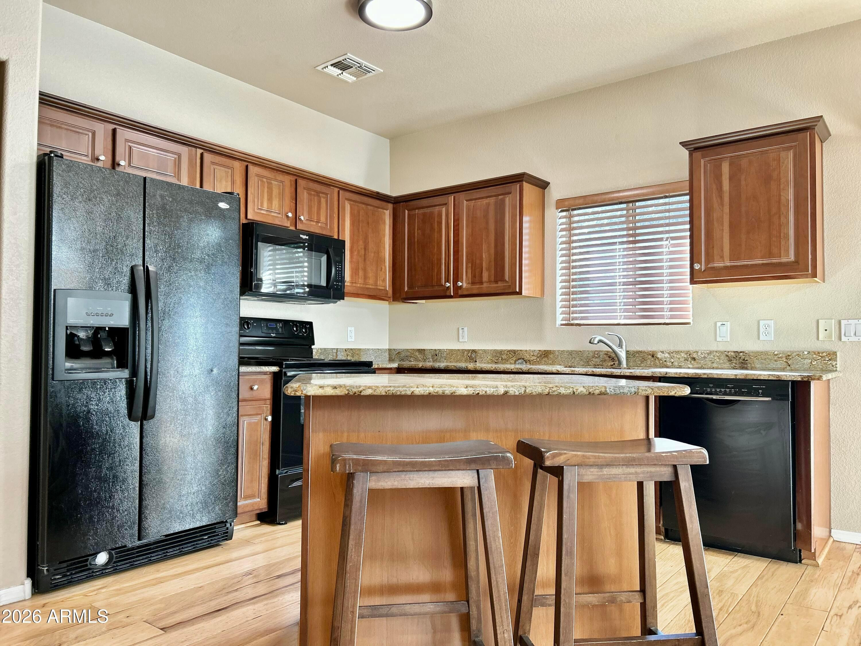 2401 East Rio Salado Parkway, Unit 1018 Tempe, AZ 85288 - Photo 6 of 19 a kitchen with granite countertop a refrigerator stove top oven and sink