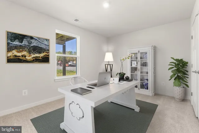 a view of a workspace with furniture and a potted plant