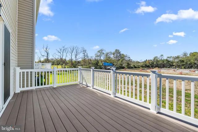 a view of balcony with wooden floor and fence