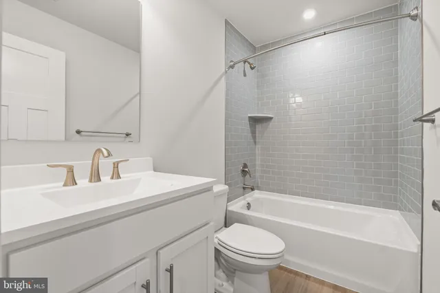 a bathroom with a sink a toilet and a bathtub