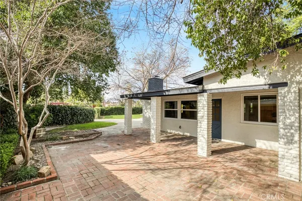 a view of a house with a tree in the background