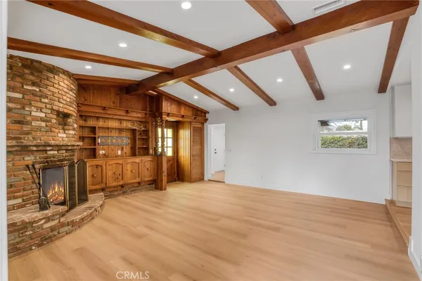a view of an empty room with a fireplace