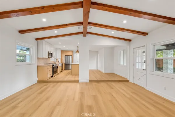 a view of a kitchen with furniture and windows