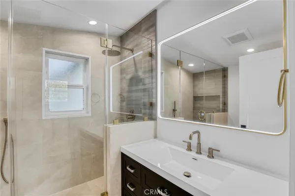 a bathroom with a sink double vanity and a mirror