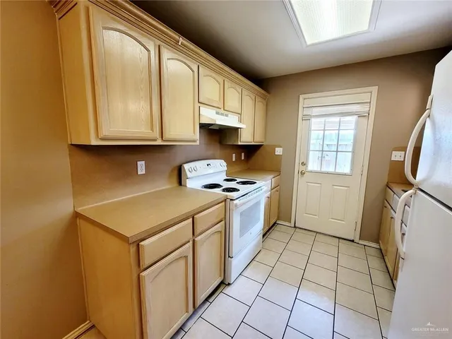 a kitchen with a sink a stove and a refrigerator