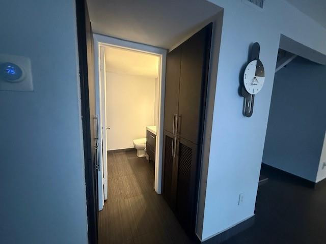 10525 Southwest 153rd Court, Unit 4 Miami, FL 33196 - Photo 17 of 33 a view of a hallway with wooden floor and a bookshelf