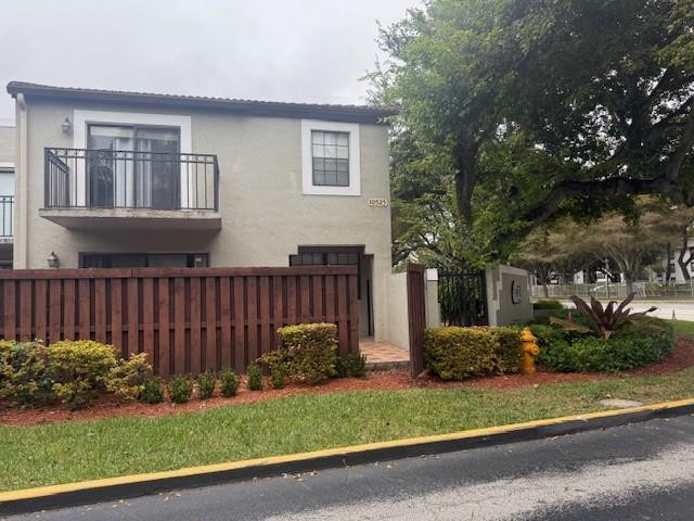 10525 Southwest 153rd Court, Unit 4 Miami, FL 33196 - Photo 2 of 33 a front view of a house with a garden