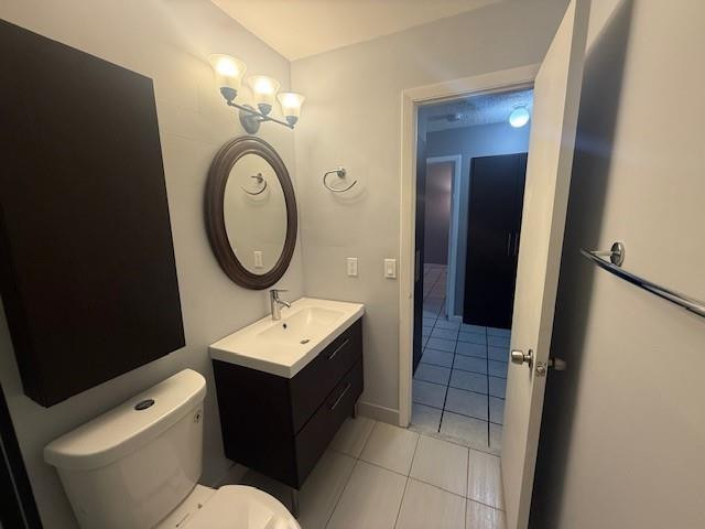 10525 Southwest 153rd Court, Unit 4 Miami, FL 33196 - Photo 27 of 33 a bathroom with a toilet a sink and a mirror