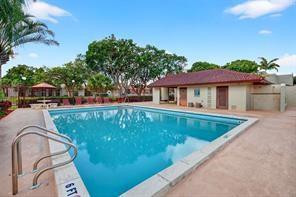 10525 Southwest 153rd Court, Unit 4 Miami, FL 33196 - Photo 33 of 33 a view of a swimming pool with a yard and plants