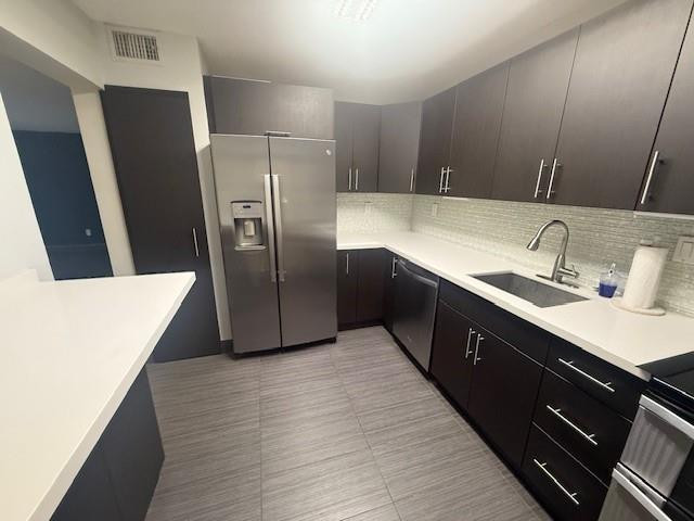 10525 Southwest 153rd Court, Unit 4 Miami, FL 33196 - Photo 10 of 33 a kitchen with stainless steel appliances a sink a refrigerator a counter space and cabinets