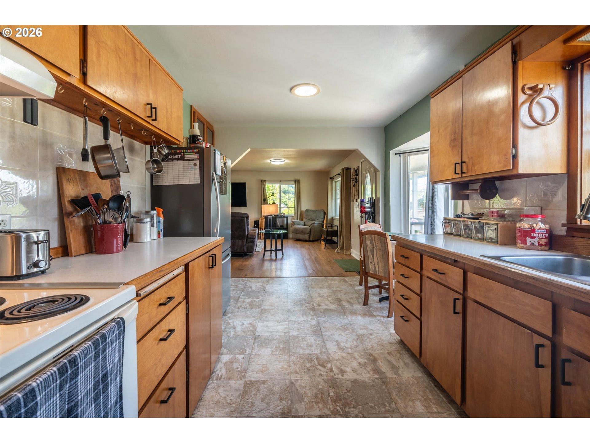 1789 14th Street North Bend, OR 97459 - Photo 18 of 43 a kitchen with stainless steel appliances granite countertop lots of counter top space and wooden floor