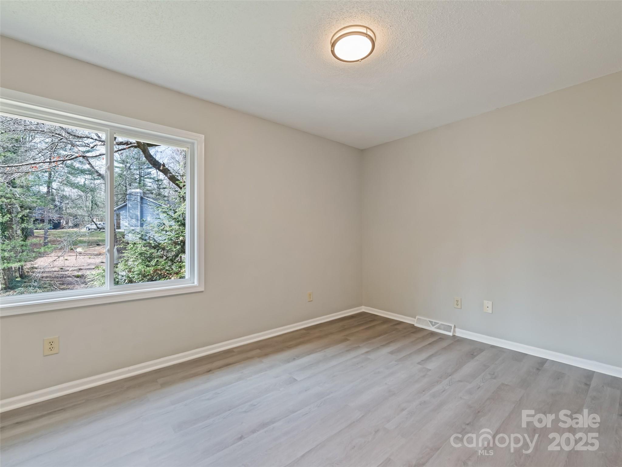10 New Bern Drive Fletcher, NC 28732 - Photo 13 of 30 an empty room with wooden floor and windows