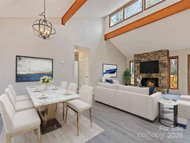 a kitchen with white cabinets and wooden floor