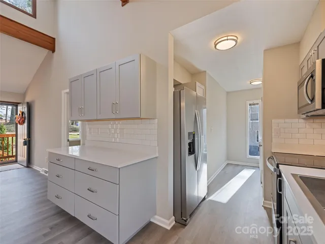a view of a kitchen with furniture wooden floor and window