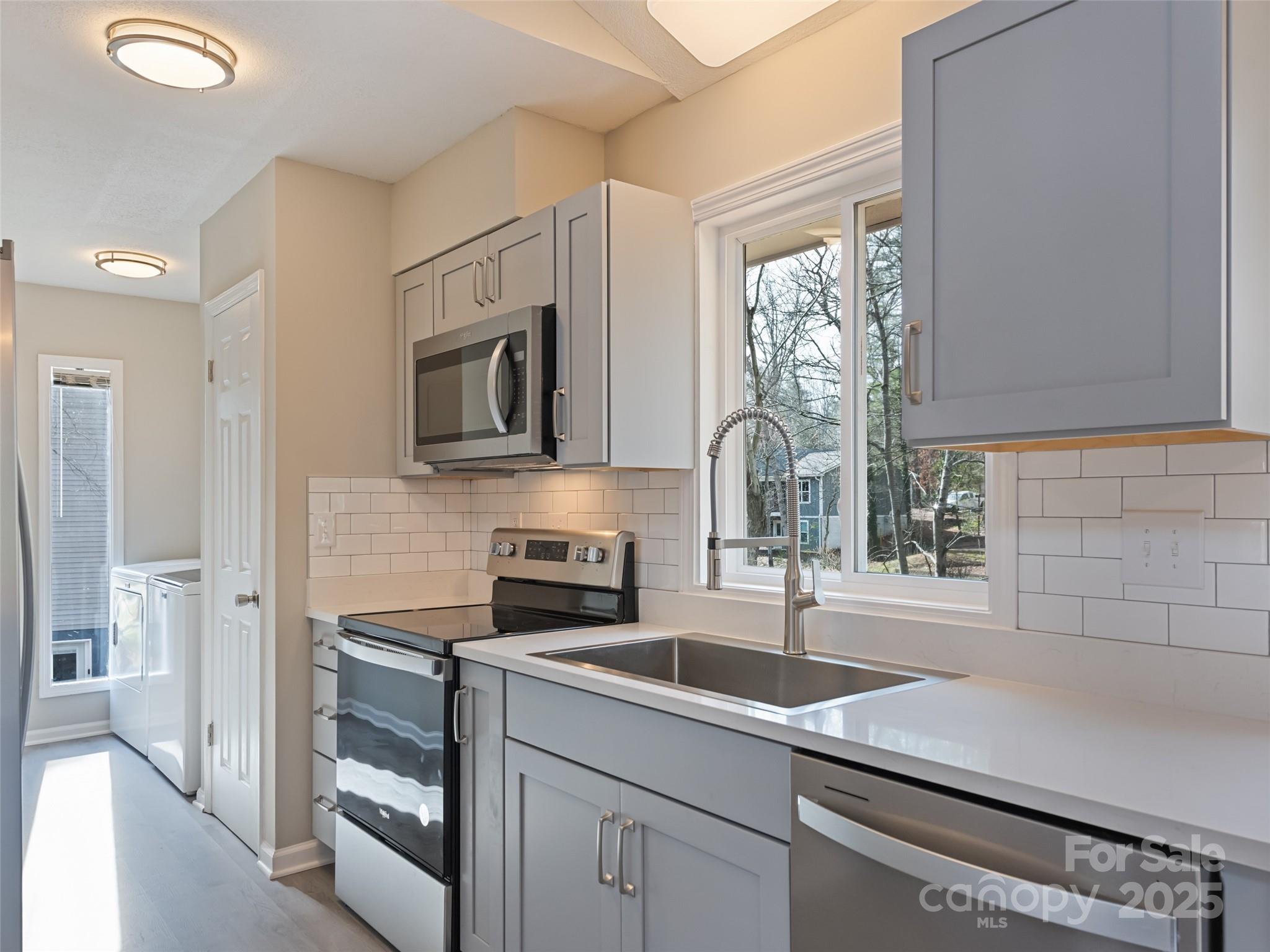 10 New Bern Drive Fletcher, NC 28732 - Photo 8 of 30 a kitchen with a sink appliances and cabinets