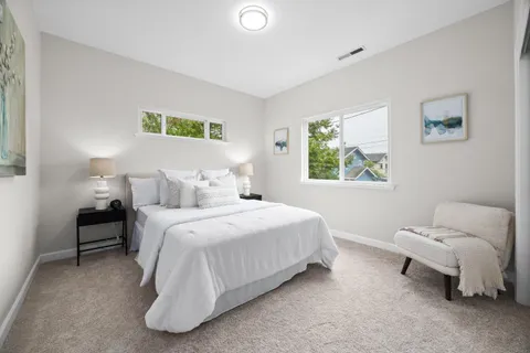 a bedroom with a bed and a couch