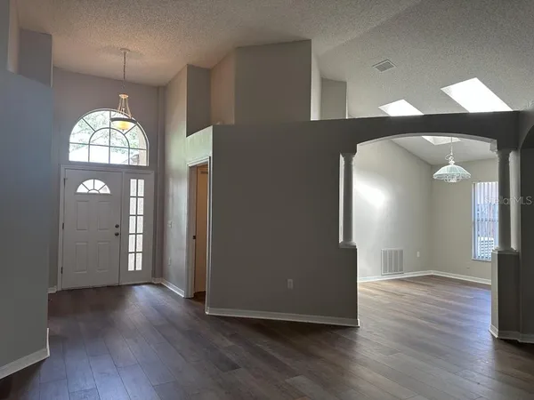 a view of a livingroom with wooden floor and entryway