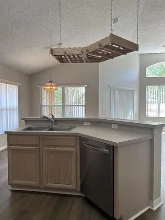 a kitchen with a sink and stove