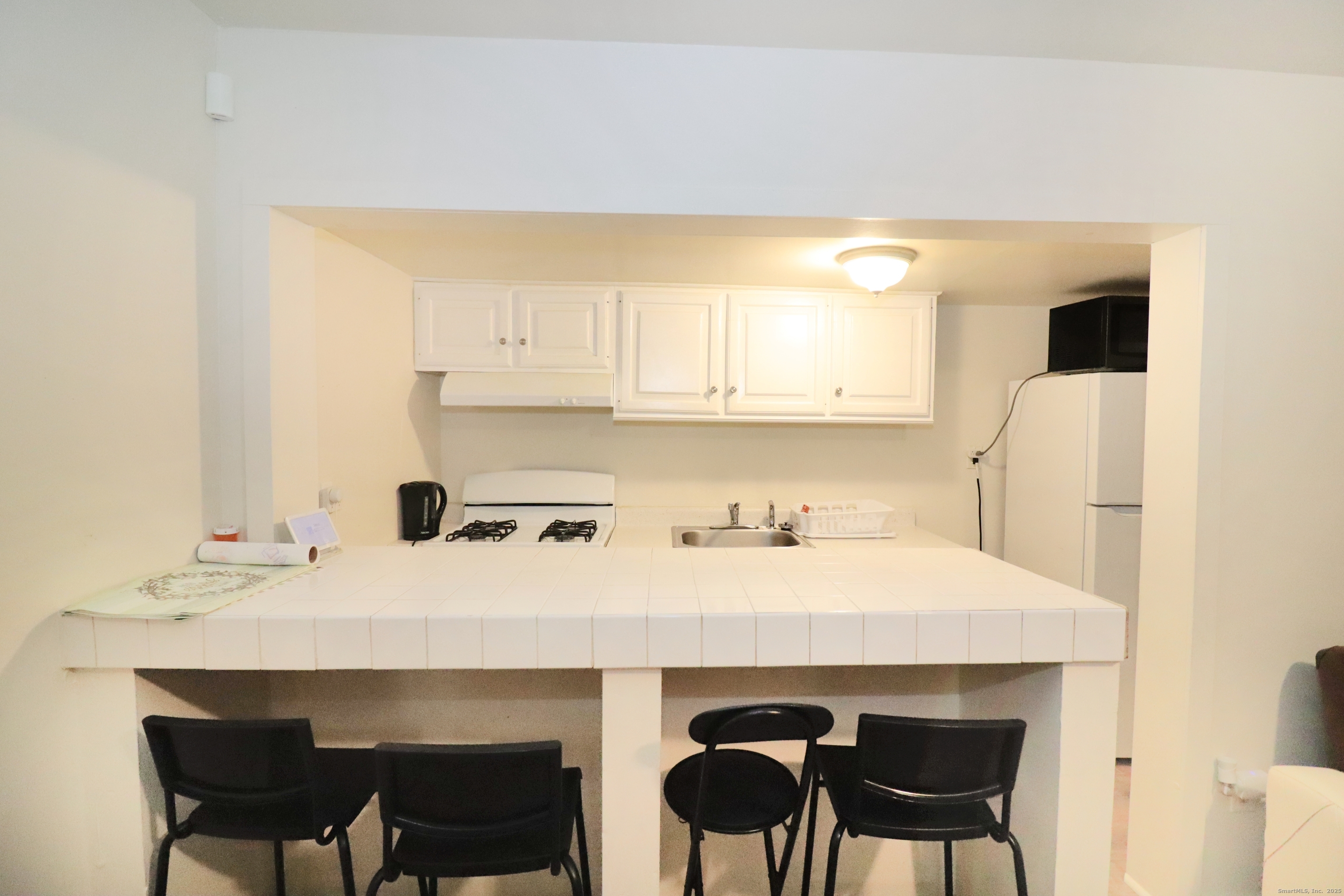 60 Olive Street Bridgeport, CT 06605 - Photo 12 of 34 a kitchen with a sink cabinets and wooden floor